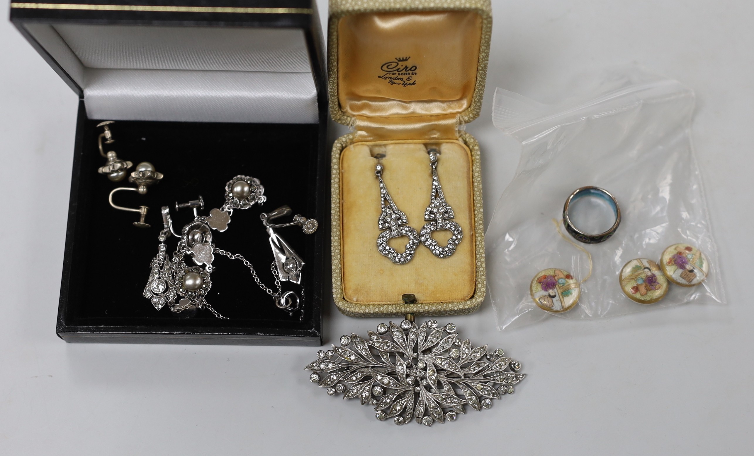 A small group of white metal and paste set jewellery, including a double clip brooch, necklace and three pairs of earrings, three satsuma buttons and a cloisonne ring.